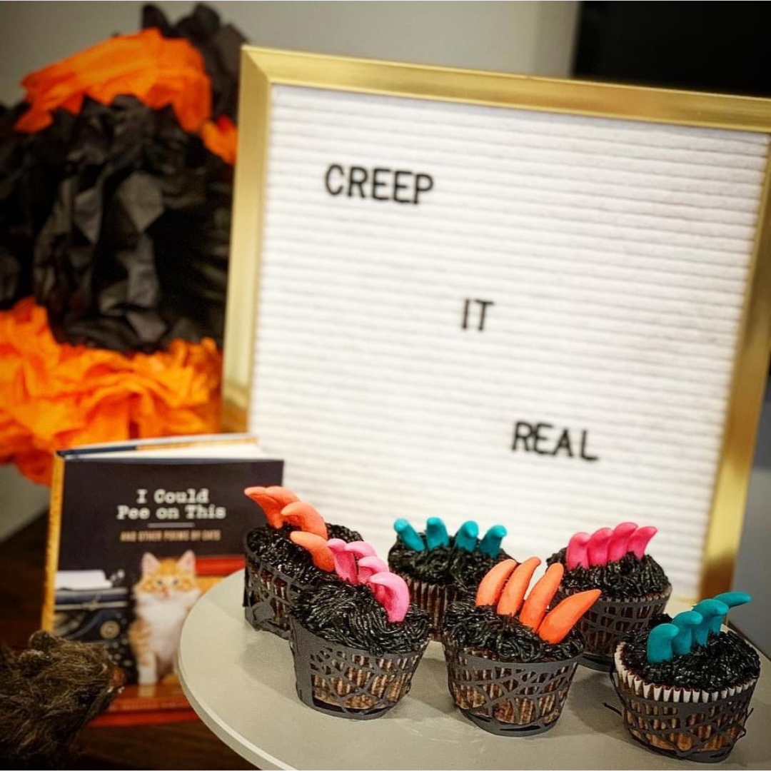 Chocolate cupcakes with dark frosting and neon candy claws crawling out of piped chocolate “fur.”
