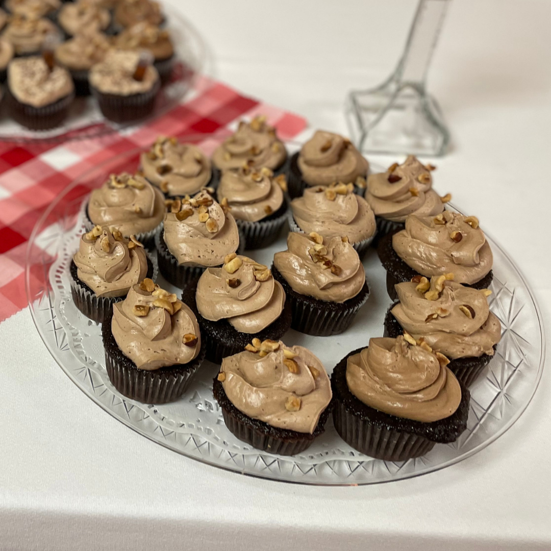 Chocolate-hazelnut cupcakes topped with Nutella frosting and toasted hazelnuts.