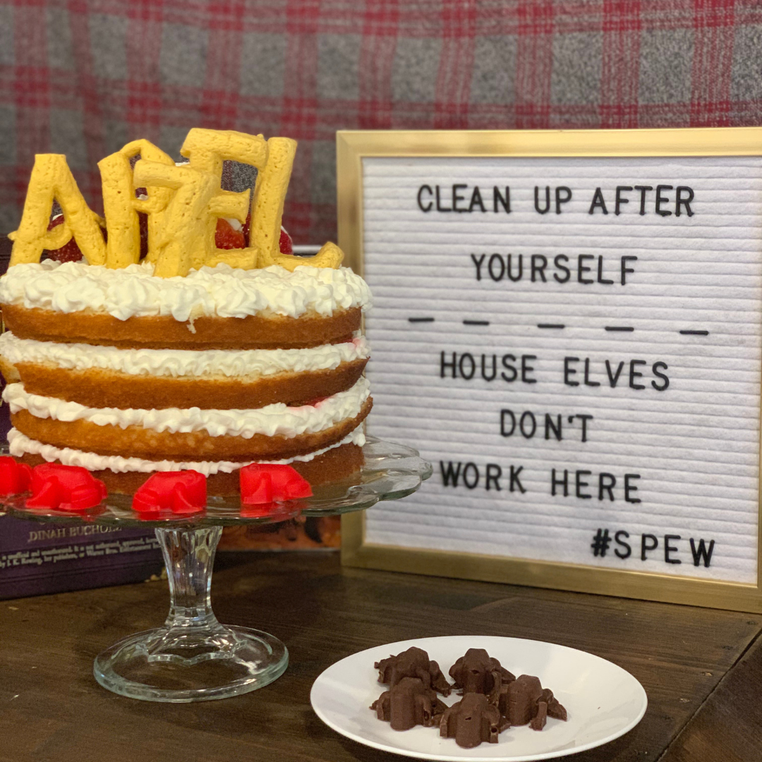 Naked strawberry shortcake cake with piped cream and “Abel & 7” Wizard cookie topper.