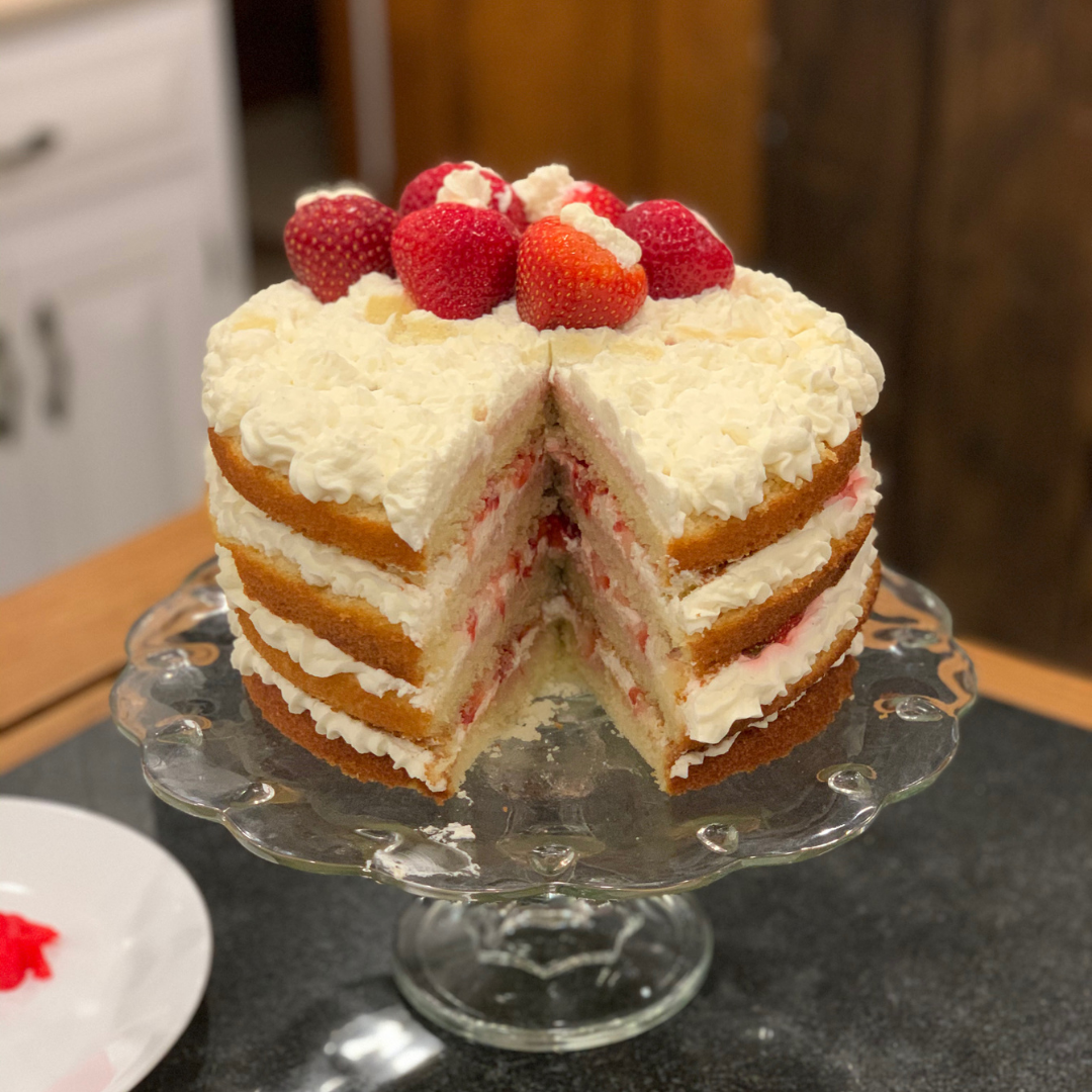 Layered strawberry shortcake with whipped cream and fresh strawberries.