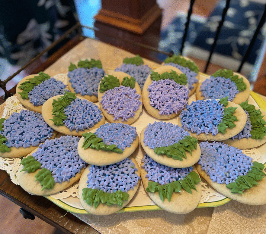 Royal icing cookies decorated with textured hydrangea blooms in soft pastel colors.